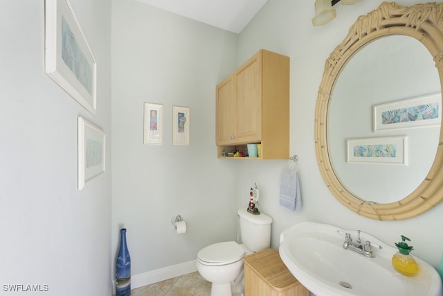 bathroom featuring sink, tile patterned flooring, and toilet