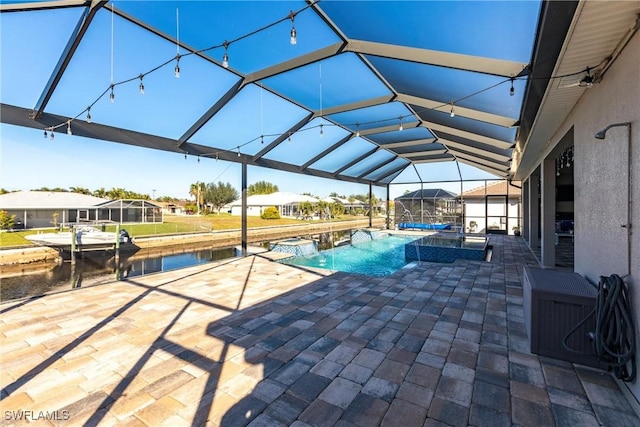 view of swimming pool featuring an in ground hot tub, glass enclosure, and a patio area