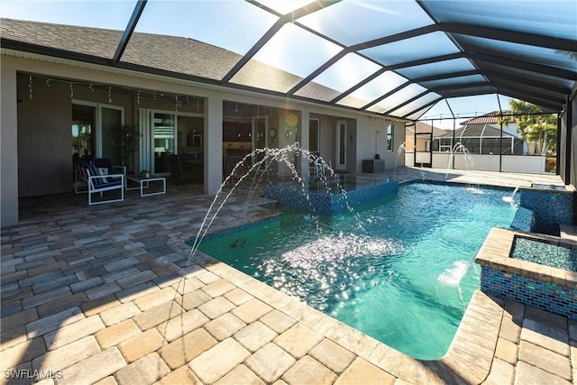 view of swimming pool featuring a patio, pool water feature, and a lanai