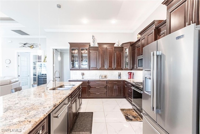 kitchen featuring sink, decorative backsplash, hanging light fixtures, light stone counters, and stainless steel appliances