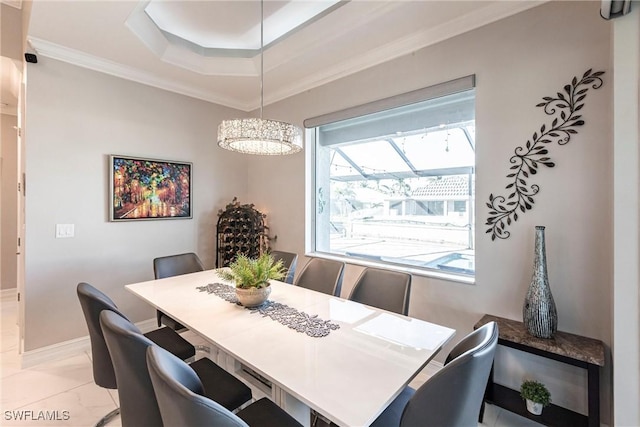 dining room with crown molding and a raised ceiling