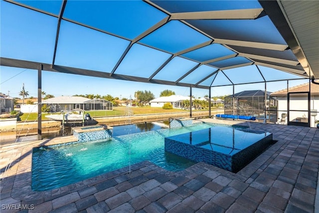 view of swimming pool featuring an in ground hot tub, pool water feature, glass enclosure, and a patio area