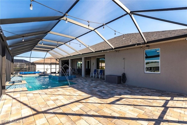 view of swimming pool with a patio area, pool water feature, and glass enclosure