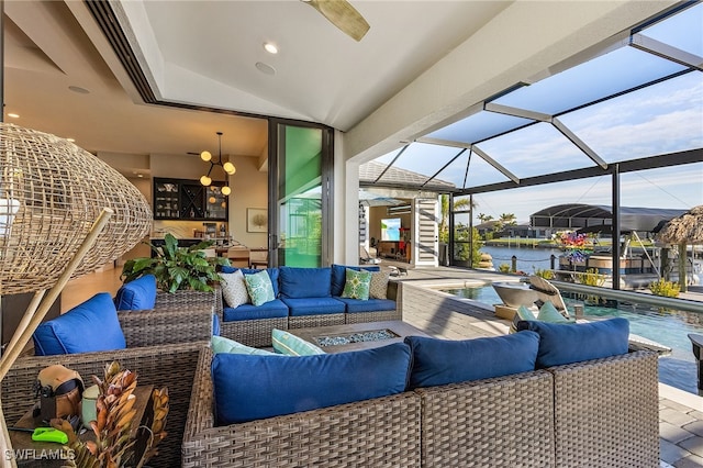 view of patio / terrace featuring a water view, a lanai, an outdoor living space, and a jacuzzi