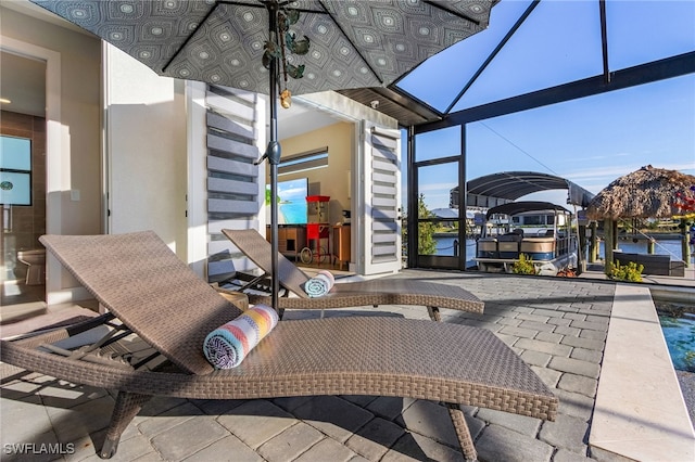 view of patio with glass enclosure and a dock