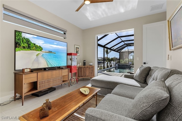 living room with visible vents, a ceiling fan, lofted ceiling, a sunroom, and tile patterned flooring