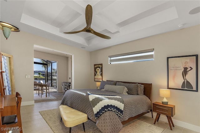 bedroom featuring access to exterior, multiple windows, a raised ceiling, and a ceiling fan