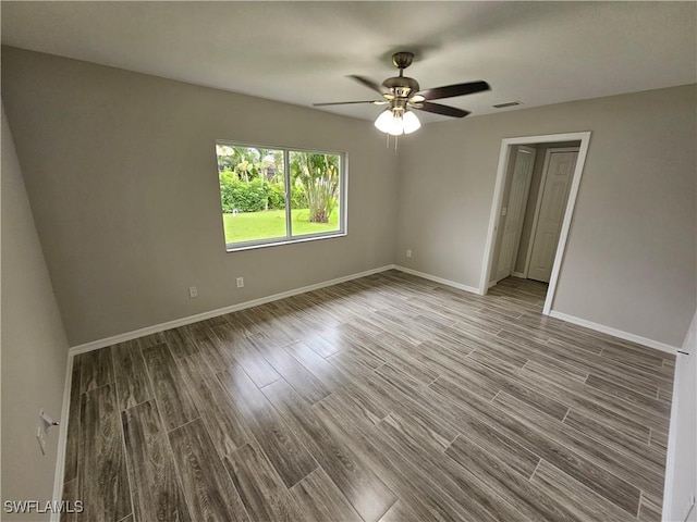 empty room with wood-type flooring and ceiling fan