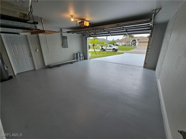 garage with a garage door opener and electric panel