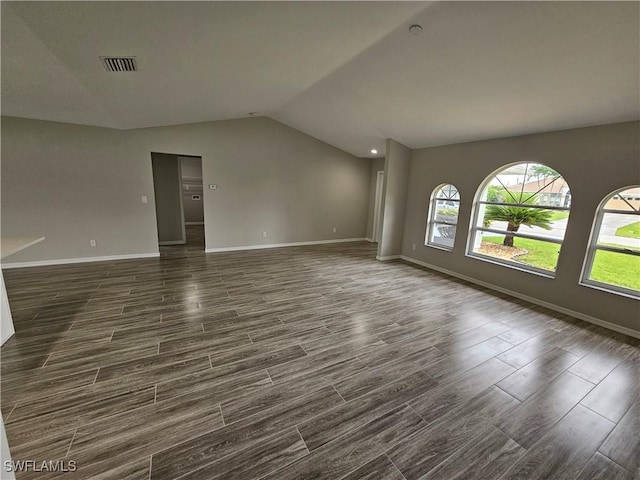 empty room featuring lofted ceiling