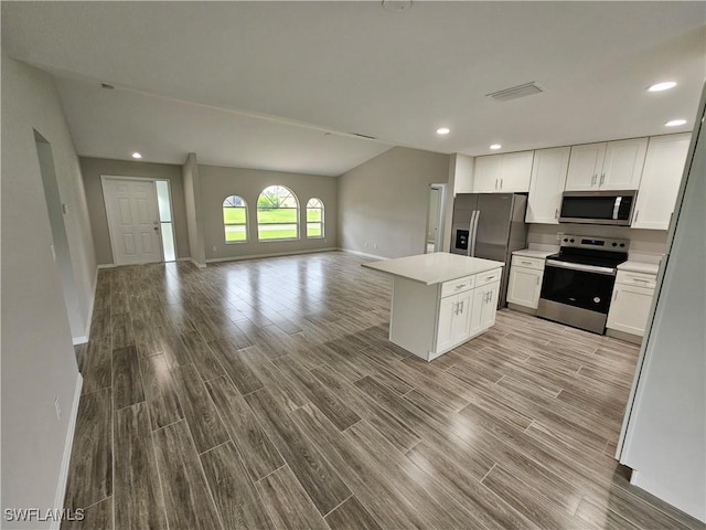 kitchen with white cabinetry, light wood-type flooring, stainless steel appliances, and a kitchen island