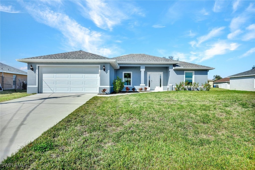 view of front of property with a garage and a front yard