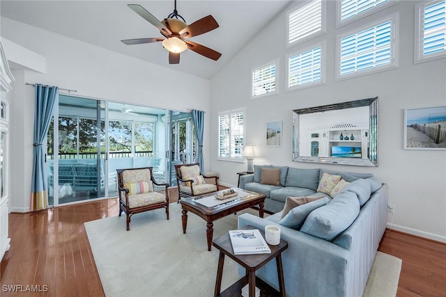 living room featuring high vaulted ceiling, hardwood / wood-style floors, and ceiling fan