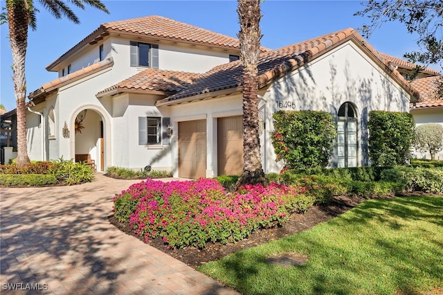 mediterranean / spanish-style house featuring a garage