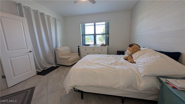 bedroom with ceiling fan and light tile patterned floors