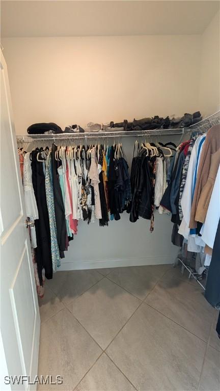 walk in closet featuring tile patterned flooring