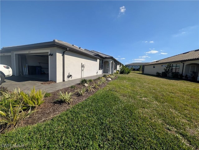 view of property exterior featuring a garage and a lawn