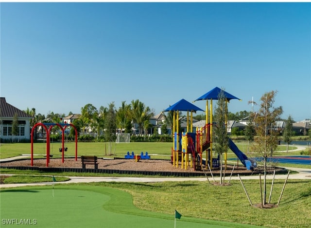 view of playground with a lawn