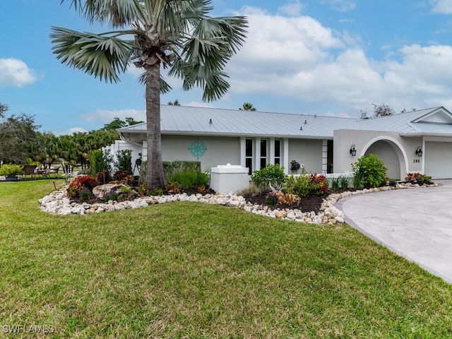 ranch-style house featuring a garage and a front yard