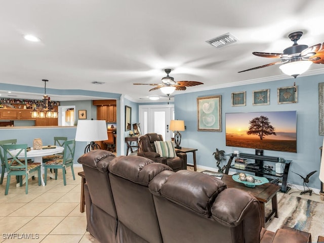 tiled living room featuring ceiling fan and ornamental molding