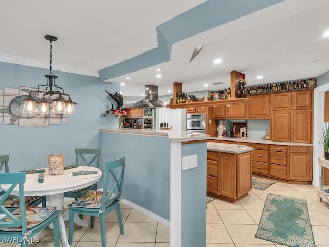 kitchen featuring crown molding, hanging light fixtures, a kitchen island, island exhaust hood, and light tile patterned flooring