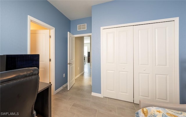 tiled bedroom featuring a closet