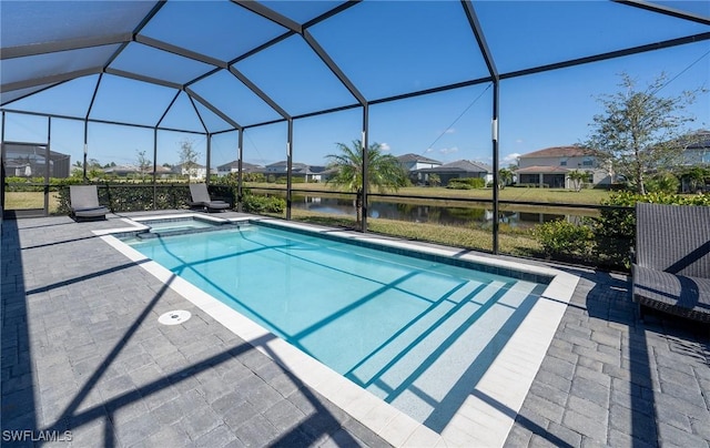 view of pool featuring a patio, a water view, and glass enclosure