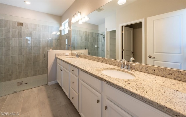 bathroom featuring vanity and a shower with shower door