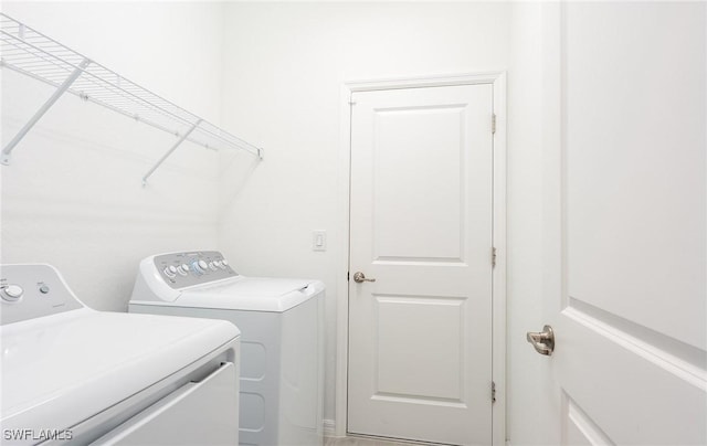 laundry room featuring washing machine and clothes dryer