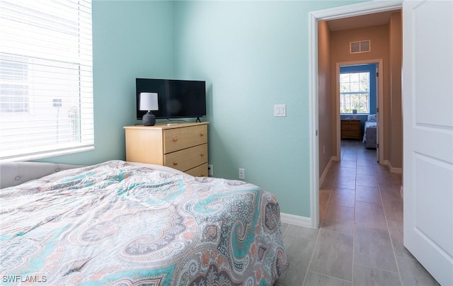 bedroom with light tile patterned floors