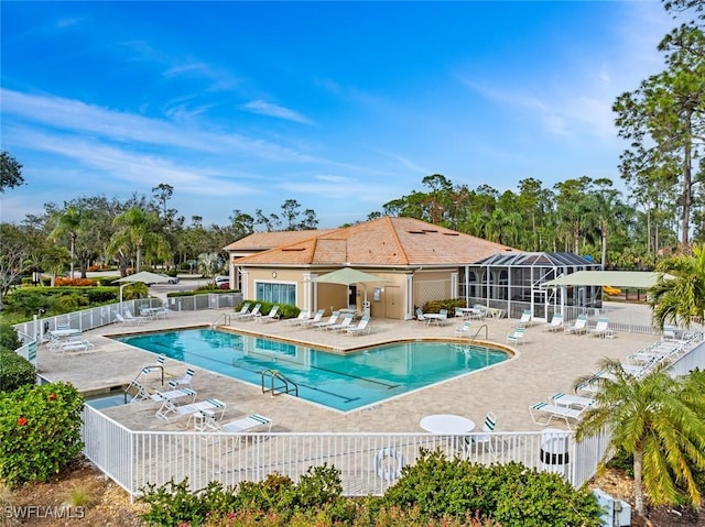 view of swimming pool featuring a lanai and a patio area