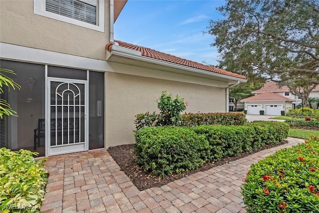 view of exterior entry featuring a garage