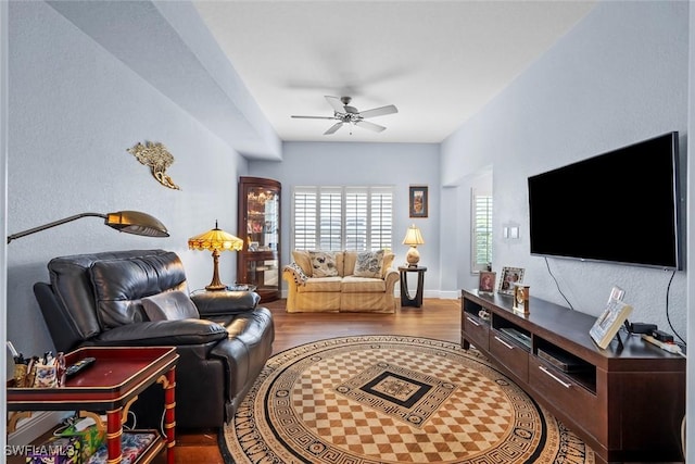 living room featuring wood-type flooring and ceiling fan