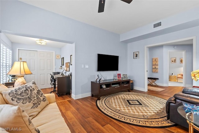 living room featuring ceiling fan and light hardwood / wood-style floors