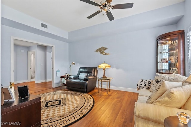 living room with hardwood / wood-style flooring and ceiling fan