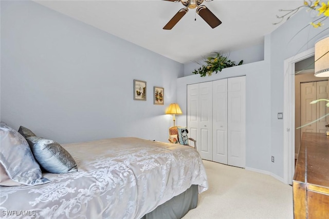 carpeted bedroom with ceiling fan and a closet