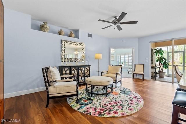 living room featuring wood-type flooring and ceiling fan