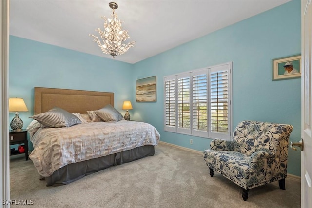 bedroom featuring carpet and an inviting chandelier