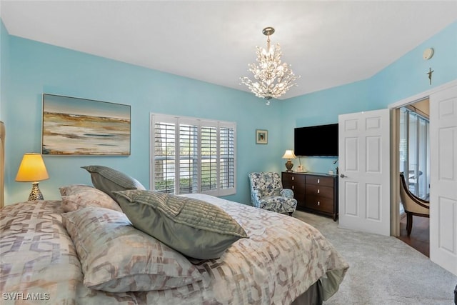 carpeted bedroom with a notable chandelier