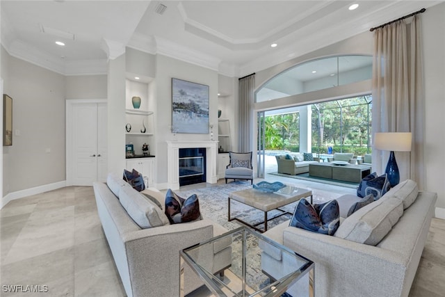 living room featuring ornamental molding, a towering ceiling, and built in features