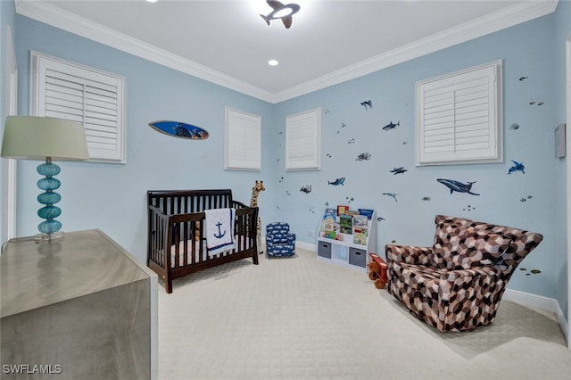 bedroom with a crib, ornamental molding, and carpet