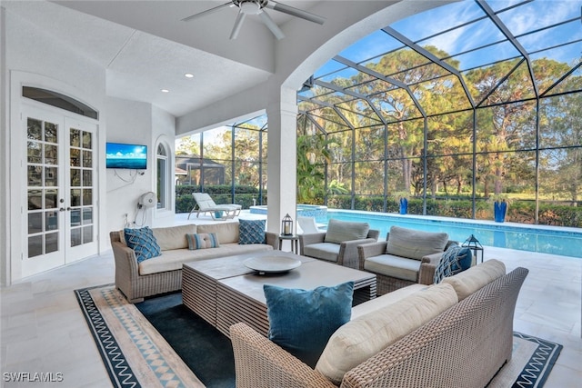 view of patio / terrace featuring an outdoor living space, ceiling fan, glass enclosure, and french doors