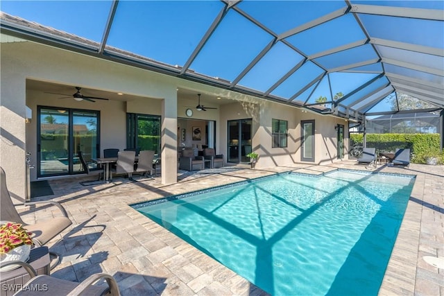 view of pool with a patio, a lanai, and ceiling fan