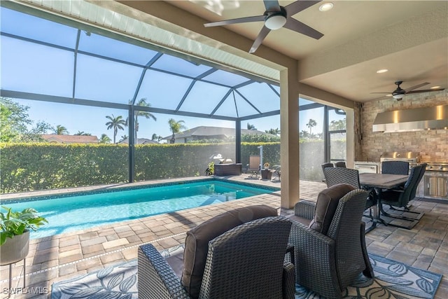 view of swimming pool with a lanai, a patio area, and ceiling fan