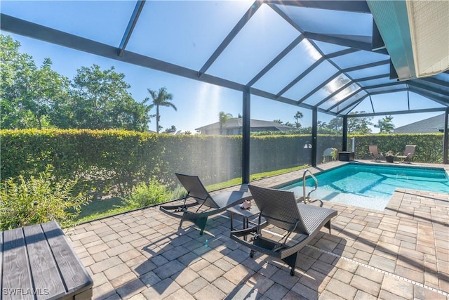 view of swimming pool with a lanai and a patio area