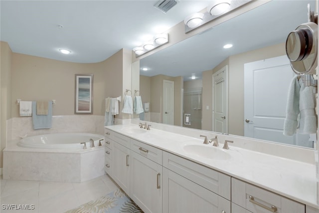 bathroom with tile patterned flooring, vanity, and shower with separate bathtub