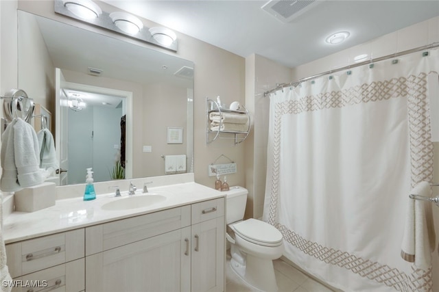 bathroom with vanity, tile patterned flooring, curtained shower, and toilet