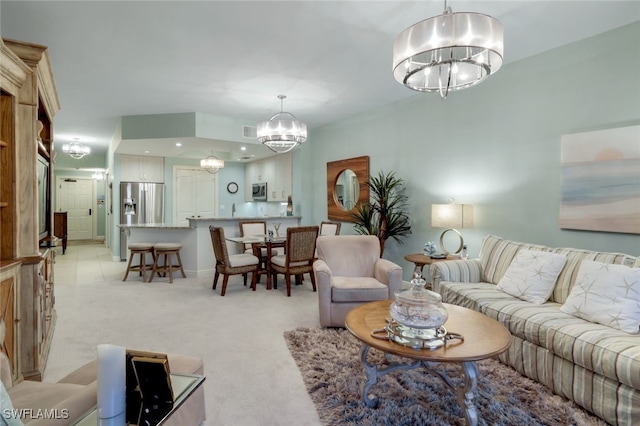 living room featuring light colored carpet and a notable chandelier