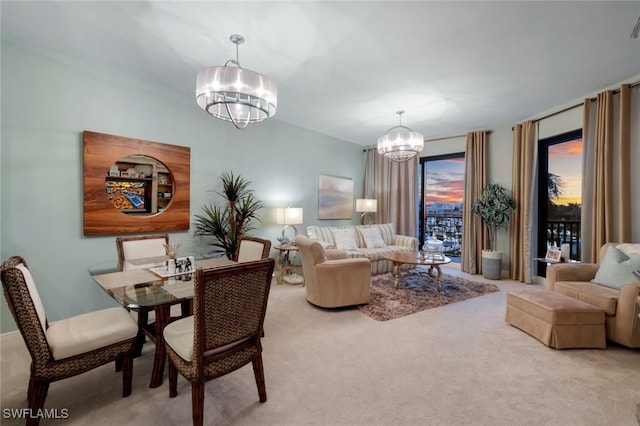 carpeted living room with an inviting chandelier