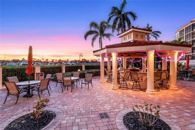 patio terrace at dusk with a bar and a gazebo